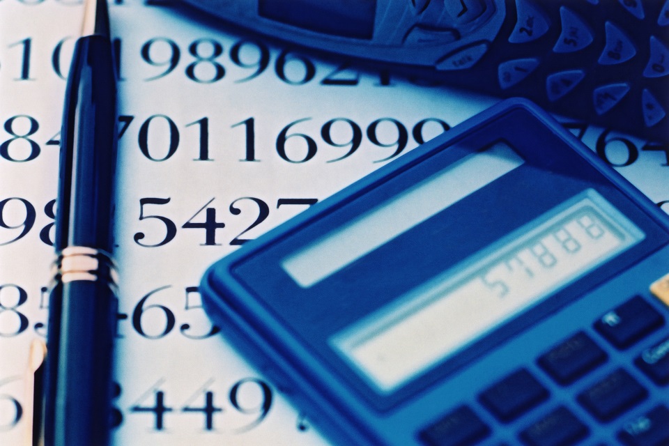 Calculator and pen on desk