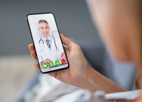 pet-telemed image of person consulting veterinarian via mobile phone