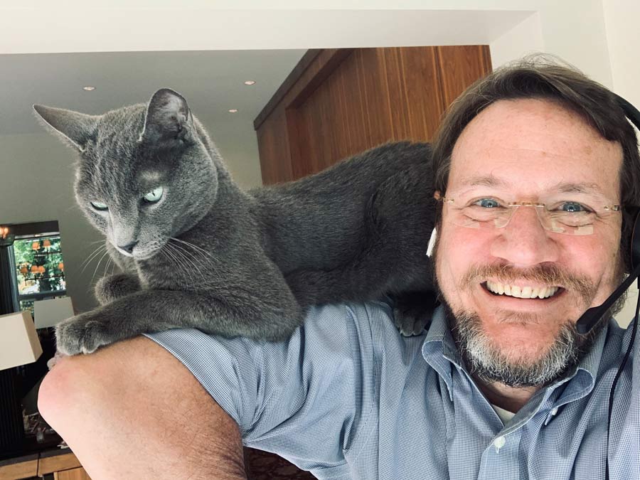 Chief Medical Officer for CDC’s COVID-19 response John Brooks social distances from home office with his cat, Cosmo.