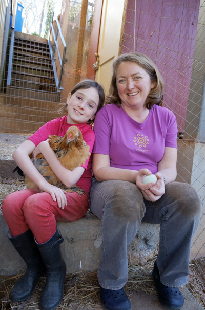 p1002-healthy-pets.jpg Young girl with her mom holding a hen