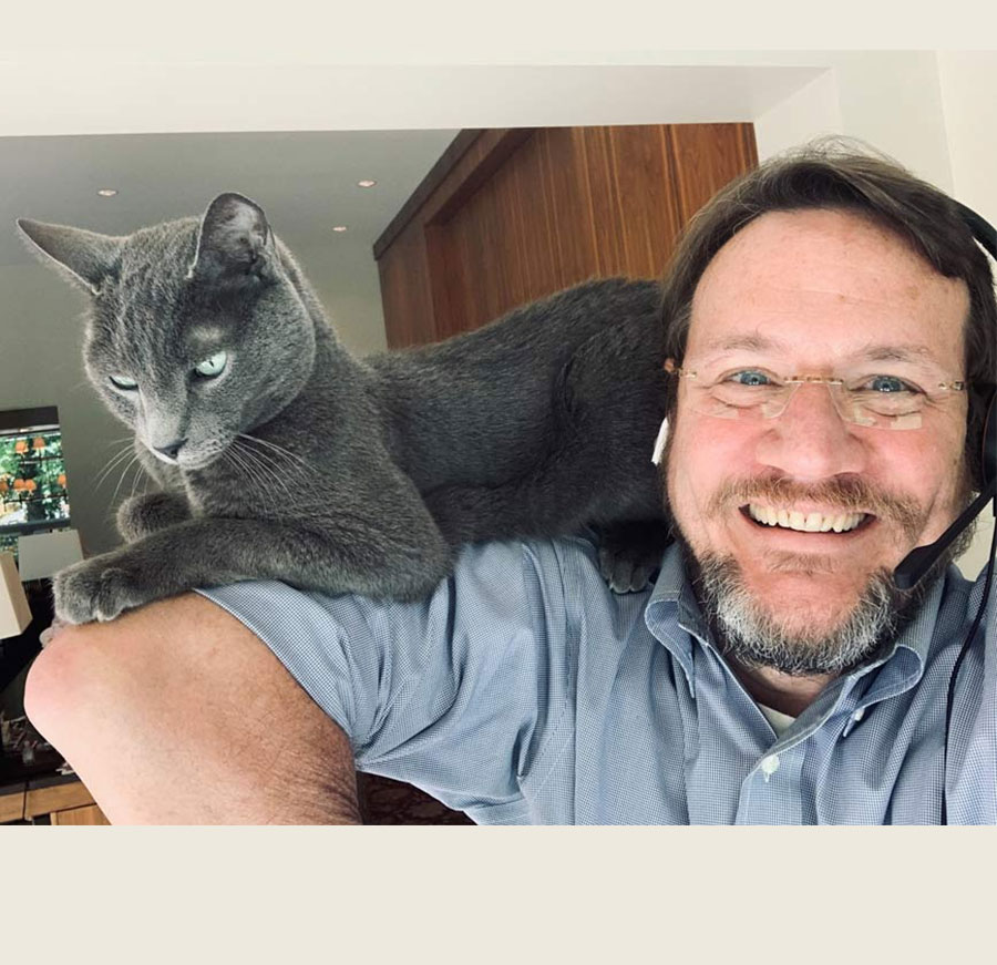 Chief Medical Officer for CDC’s COVID-19 response John Brooks social distances from home office with his cat, Cosmo.
