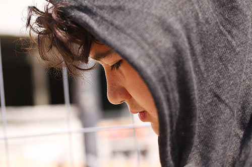 teenager wearing a hoodie outdoors