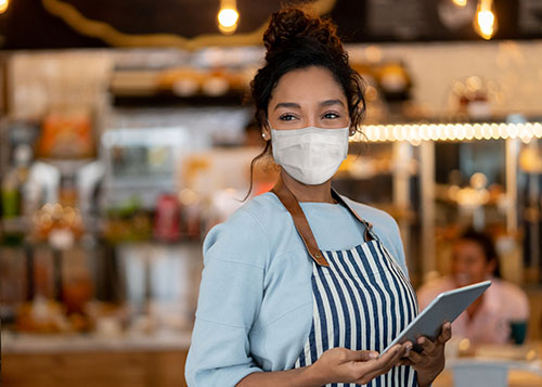 Server working at a restaurant wearing a facemask