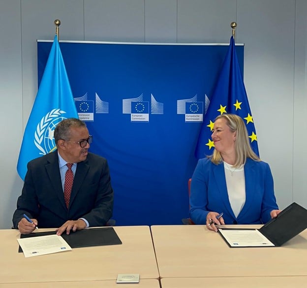 WHO Director-General Dr Tedros Adhanom Ghebreyesus and EU Commissioner for International Partnerships Jutta Urpilainen sign documents