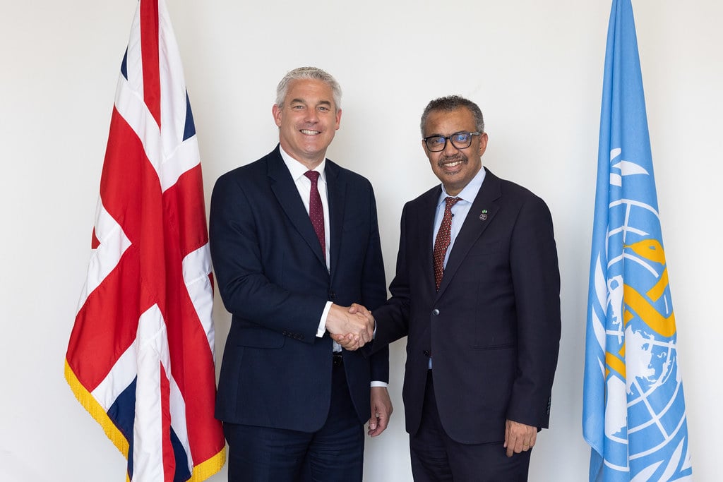 WHO Director-General Dr Tedros Adhanom Ghebreyesus and UK Secretary of State for Health and Social Care Steve Barclay MP shake hands